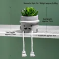Detail of creative succulent cement pot featuring human-like face and rope hanging legs - Mustache Style