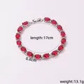 Macro view of copper plated bracelet with red oval zircons and micro-pave detailing - Red