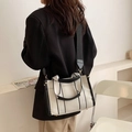 Minimalist canvas tote bag with black trim, featuring top handles and a wide shoulder strap - Small / Black