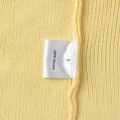 Detail view of ginger yellow knitwear showing 100% Viscose care label and soft texture - S / Ginger Yellow (100% Viscose)