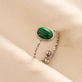 Macro shot of silver adjustable ring with malachite stone on satin fabric - Silver Base-Malachite Green Stone