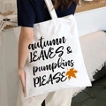 White canvas tote bag with autumn leaves and pumpkins slogan shown in lifestyle view - Autumn Leaves & Pumpkins Please / White