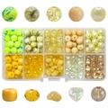 Detailed view of yellow crystal beads and glass charms in a 10-grid storage box for DIY jewelry - 200Pcs/Box / Golden Yellow Series