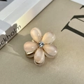 Elegant peach resin flower hair claw with sparkling rhinestone and golden metal base - White Gradient