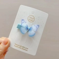 Close-up of handmade tulle butterfly hair clip with blue gradient and rhinestones - Blue and Purple