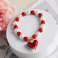 Exotic red and white bead bracelet featuring a vibrant red heart charm and golden beads - Style G-Large Red Heart