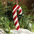 Red and white striped metal candy cane ornament with festive holiday background - Candy Cane