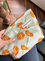 Canvas makeup bag with orange flowers and A GOGO ORIGINAL tag in cream-green - Calla Lily Orange