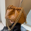 Brown quilted leather chain bucket bag with drawstring closure and gold ball pendant - Brown