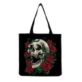 Close-up of gothic skull and red rose floral print on black canvas tote bag surface - Realistic Skull and Red Rose Vines Art (hm6640)