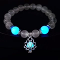 Glow-in-the-dark yoga bracelet with white turquoise beads and a luminous lotus charm - 10mm White Cat's Eye with Blue Light