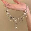 Detail of silver drop pendant necklace with clear and champagne crystals held in hand - 4# Silver Champagne Flower Style