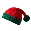 Close-up of red and green knitted Christmas hat with pom-pom and thick ribbed texture - One Size / Red + Green Adult
