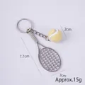 Mini tennis racket keychain featuring a yellow fuzzy ball and silver alloy frame - 2cm Small Light Yellow Tennis Ball + Silver Racket
