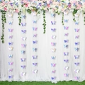 Close-up of iridescent laser cut butterfly garlands hanging on a white wedding backdrop - 3m Iridescent 3D Butterfly Garland