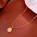 Detail of gold titanium flower pendant necklace with starburst engraving and micro-inlay - Gold
