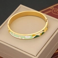 Detailed macro shot of vintage gold-plated enamel bracelet with abstract eye pattern - Green & White Geometric (7#)