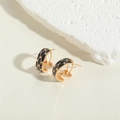 Detail of C-shaped gold-plated hoop earring featuring black animal pattern drip oil glaze - Black
