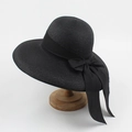 Foldable black straw sun hat for women featuring a wide brim and elegant bow ribbon detail - Adjustable / Black