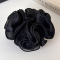 Detail of a black satin rose hair scrunchie with layered ruffles and elegant glossy finish - Black