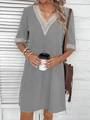 Detail of white crochet lace trim on the V-neck and sleeves of a grey casual dress - Gray