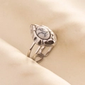 Detail of silver stainless steel ring with white marble stone on beige fabric background - Silver-White