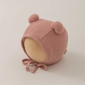 Detail of baby knit bonnet with double ear pom-poms and tie strap in dusty rose pink - 0-12 Months / Pink