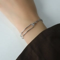 Minimalist silver chain bangle with geometric arc design worn on wrist for daily styling - Lip Chain Intertwined Fashion Bracelet