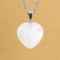 Detailed macro view of white crystal heart pendant necklace with silver chain link - White Crystal