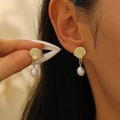 Detailed close-up of golden shell stud earring with elegant white pearl pendant drop - Scallop Artificial Pearl Earrings (5400) / Light KC Gold