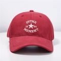 Close-up of white 'IN THE MOMENT' embroidery on red cotton baseball cap detail - One Size (Adjustable) / Red