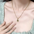 Golden snake chain necklace featuring a polished green teardrop gemstone pendant - Ocean Green Waterdrop