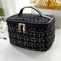 Elegant black tweed makeup bag with gold thread accents and double gold zipper detail - Black