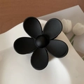 Matte black flower hair claw clip with minimalist five-petal design on white tray - 7cm / Black