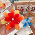 Handmade red and yellow plush flower brooch with center pearl detail and cute bow design - Orange-Red Fireworks Accessory / One Size
