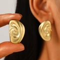Detailed view of large gold heart earrings with spiral texture and matte finish - 18K Gold Vortex