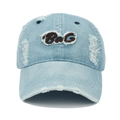 Detailed view of the BaG embroidery and distressed holes on the washed denim baseball cap - Adjustable / Light Blue