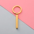 Close-up of a minimalist golden stainless steel rectangular bar pendant on a keychain - Gold (MP424)