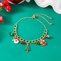 Adjustable gold charm bracelet featuring Santa, Christmas tree and bells on green background - Santa Claus & Christmas Tree & Gift Box