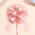 Detail view of pink pull bow flower made of layered satin ribbon and sheer organza fabric - Pale Pink