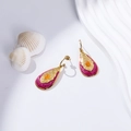 Detail of gold-plated leaf earrings with purple enamel and orange gemstone inlay - Burgundy and Orange Teardrop Style (EH003)