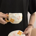 Handmade ceramic coffee cup and saucer set with orange hand-painted floral pattern - Orange Flower
