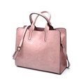 Detail of pink faux leather handbag with detachable shoulder strap and black oil edges - Pink