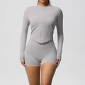 Close-up of women's light grey yoga set with zip-up jacket and high waist shorts - Frost Grey