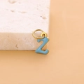 Golden number 2 pendant with blue enamel finish on a beige textured stone background - Enamel Letter-Z