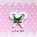 Detail of Christmas candy cane resin charms with green bow for DIY craft projects - Connected Candy Canes - Blue