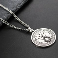 Macro view of silver stainless steel wolf pendant necklace with roar animal engraving - Steel Bear