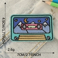 Retro cassette embroidery patch with mountain scene on blue denim background - FINE BRAVE Mountain Cassette (E3L-B-1-8 Heat Melt)