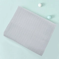Folded double-layer gray cotton muslin swaddle blanket for infants on green background - Light Gray