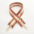 Close-up of a 5cm wide woven bag strap with brown, white and gold glitter stripes - Gold Buckle / Brown